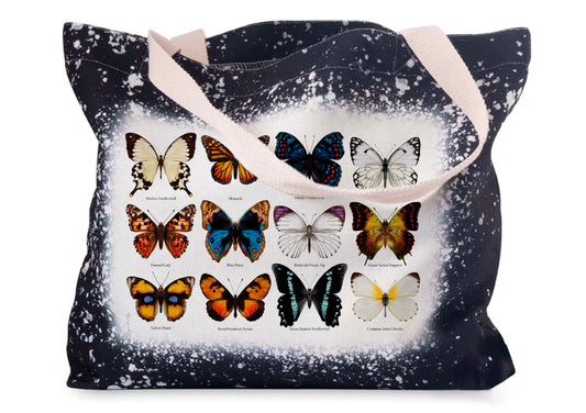 A black linen tote bag featuring hand-drawn butterfly designs on the side, with a bleached-style trim and durable handles.